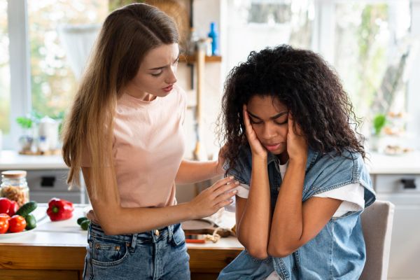 Image of a lady battling with peer pressure and academic stress while her mother consoles her